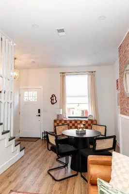 a living room with a table and chairs at Quiet close to NYC BBQ Deck in Jersey City