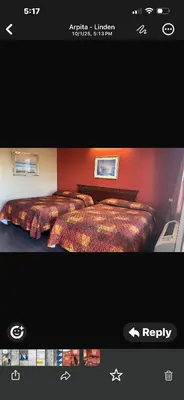 a screen shot of a bedroom with a bed at Linden Motor Inn in Linden