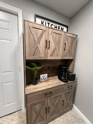 a wooden cabinet with wooden doors in a room at Cozy Modern Home with Large Fenced in Backyard in Camden