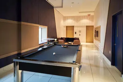 a pool table in the middle of a room at W residence in New York