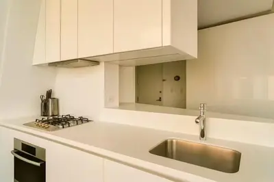 a white kitchen with a sink and a stove at W residence in New York