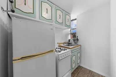 a kitchen with a white refrigerator and a sink at NY-11-7 Cozy 1BR 1BATH In East Village in New York