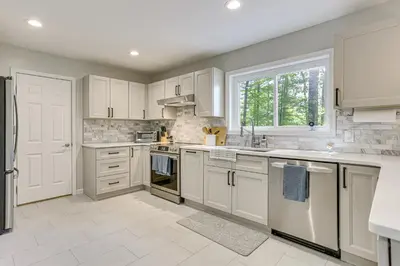 a kitchen with white cabinets and a sink at Boat, Fish and Unwind Waterfront Gem in Pocono Mtns in Lake Ariel