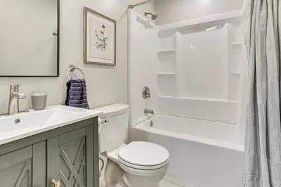 a bathroom with a toilet and a sink and a shower at Boat, Fish and Unwind Waterfront Gem in Pocono Mtns in Lake Ariel