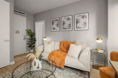 a living room with a white couch and a table at Chic NYC Retreat Beside Broadway & Iconic Sights in New York