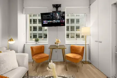 a living room with a couch and chairs and a table at Chic NYC Retreat Beside Broadway & Iconic Sights in New York