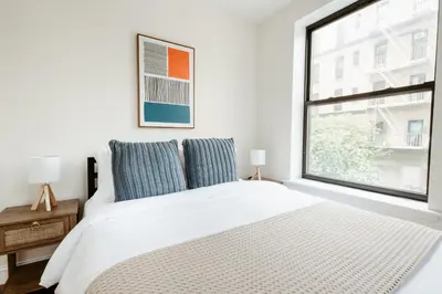 a bedroom with a white bed and a window at 3BD 2BA in Upper West Side Manhattan! 5 Star Location in New York