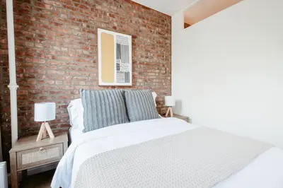 a bedroom with a brick wall and a bed at 3BD 2BA in Upper West Side Manhattan! 5 Star Location in New York