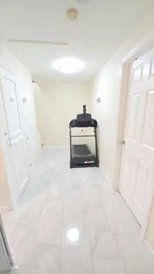 a room with a treadmill in the middle of a room at Staten Island Cozy Private 1-br Basement Apt close to NYC Family & Pet Friendly in Willowbrook