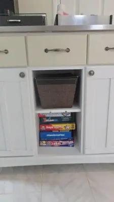 a white cabinet with a drawer filled with books at Staten Island Cozy Private 1-br Basement Apt close to NYC Family & Pet Friendly in Willowbrook