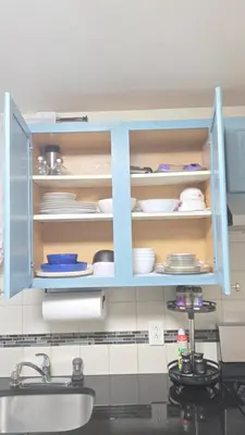 a kitchen cabinet with plates and dishes in it at Staten Island Cozy Private 1-br Basement Apt close to NYC Family & Pet Friendly in Willowbrook