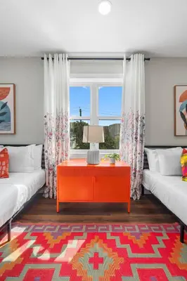 a living room with a red table and a window at Family Suite - Free Parking - Near NYC & Shops at Main Street in North Bergen