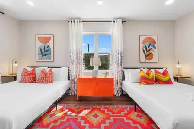 two beds in a room with a window at Family Suite - Free Parking - Near NYC & Shops at Main Street in North Bergen