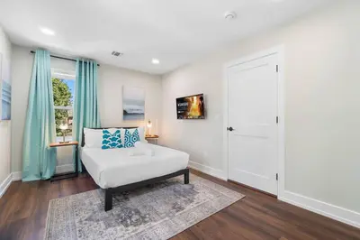 a white room with a couch and a window at Family Suite - Free Parking - Near NYC & Shops at Main Street in North Bergen