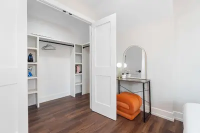 a hallway with an orange chair and a mirror at Family Suite - Free Parking - Near NYC & Shops at Main Street in North Bergen
