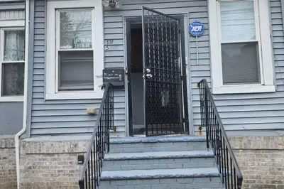 a front door of a house with a gate at Massive 5 bedroom Close to NYC in Newark