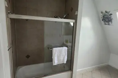 a bathroom with a shower with a white towel at Massive 5 bedroom Close to NYC in Newark
