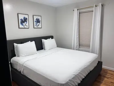 a bedroom with a large white bed with two pillows at Exquisite Luxury 3KINGs Bed, 2 Bath in Newark