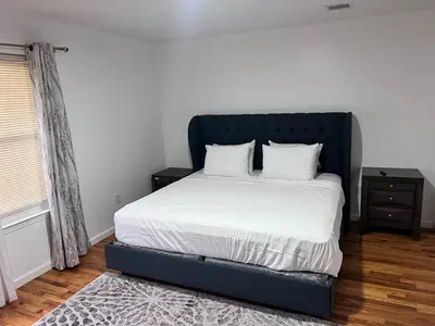 a bed with a blue frame in a bedroom at Exquisite Luxury 3KINGs Bed, 2 Bath in Newark