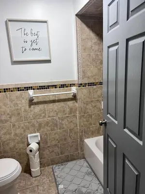a bathroom with a toilet and a sink and a door at Exquisite Luxury 3KINGs Bed, 2 Bath in Newark