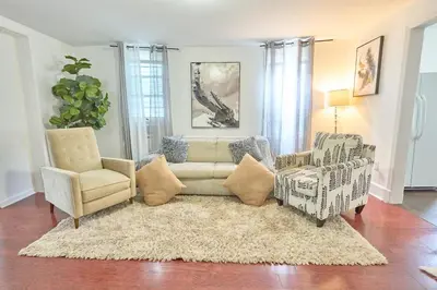 a living room with a couch and two chairs at not aavaailable is closeee in West New York