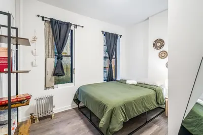 a bedroom with a bed and a window at Apartment near Times Square Manhattan New York in New York