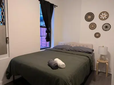a bedroom with a bed with a towel on it at Apartment near Times Square Manhattan New York in New York