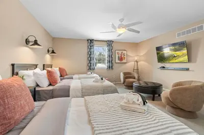a bedroom with two beds and a couch at Pine Cove Retreat - 4BR - Pool