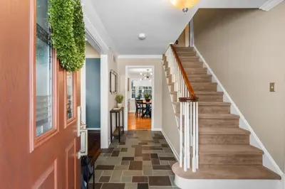 a hallway of a home with a staircase with a plant at Pine Cove Retreat - 4BR - Pool