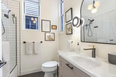 a white bathroom with a sink and a toilet at The Blue Comfort & MINS to Newyork City with parking in Jersey City