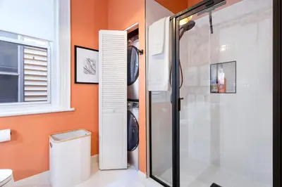a bathroom with a shower stall and a toilet at The Blue Comfort & MINS to Newyork City with parking in Jersey City