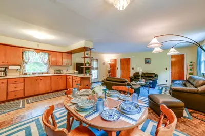 a kitchen and living room with a table and chairs at Serene Duplex with On-Site Brook in Callicoon Center in Roscoe