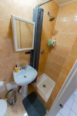 a bathroom with a shower and a sink and a toilet at Hells Kitchen Hideaway in New York