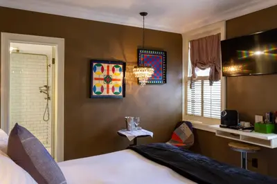 a bedroom with a bed and a table and a window at Logan Inn in New Hope