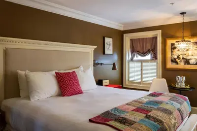 a bedroom with a large bed with red pillows at Logan Inn in New Hope