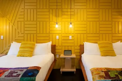a room with two beds and a laptop on a table at Logan Inn in New Hope