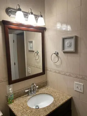 a bathroom with a sink and a mirror at Quiet apt only 15 mins from Midtown NYC in Jersey City