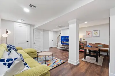 a living room with a yellow couch and a table at NYC Edge Triplex Full House | Parking & Near Shops in North Bergen