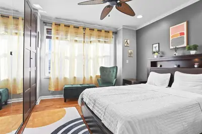 a bedroom with a bed and a ceiling fan at Fishtown Fun 2BR Fireplace in Philadelphia