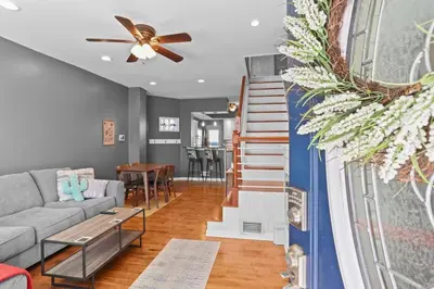 a living room with a couch and a ceiling fan at Fishtown Fun 2BR Fireplace in Philadelphia