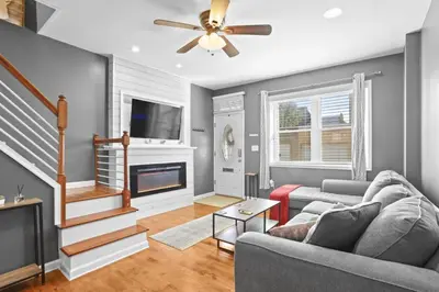 a living room with a couch and a fireplace at Fishtown Fun 2BR Fireplace in Philadelphia
