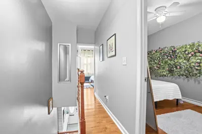 a hallway with a painting of flowers on the wall at Fishtown Fun 2BR Fireplace in Philadelphia