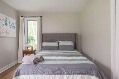 a bedroom with a large bed with towels on it at Pocono Escape Style and Serenity in Pocono Pines