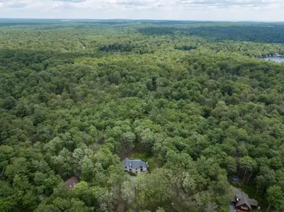an aerial view of a house in the woods at Pocono Escape Style and Serenity in Pocono Pines