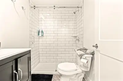 a white bathroom with a toilet and a shower at Washington Square West - Unit A in Philadelphia