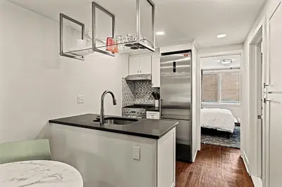 a kitchen with a sink and a refrigerator at Washington Square West - Unit A in Philadelphia