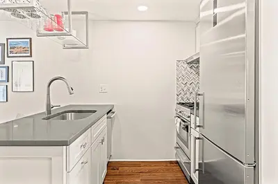 a white kitchen with a stainless steel refrigerator at Washington Square West Unit B in Philadelphia