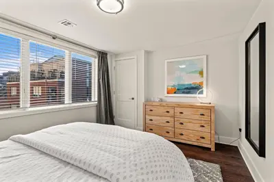 a bedroom with a bed and a dresser and a window at Washington Square West Unit B in Philadelphia