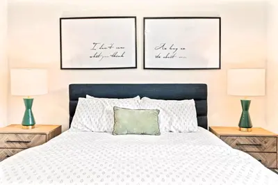 a bedroom with two lamps and a bed with a green pillow at Washington Square West Unit B in Philadelphia
