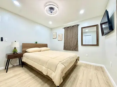 a bedroom with a bed and a flat screen tv at Historic Barn View Modern Country Newton House in Newton